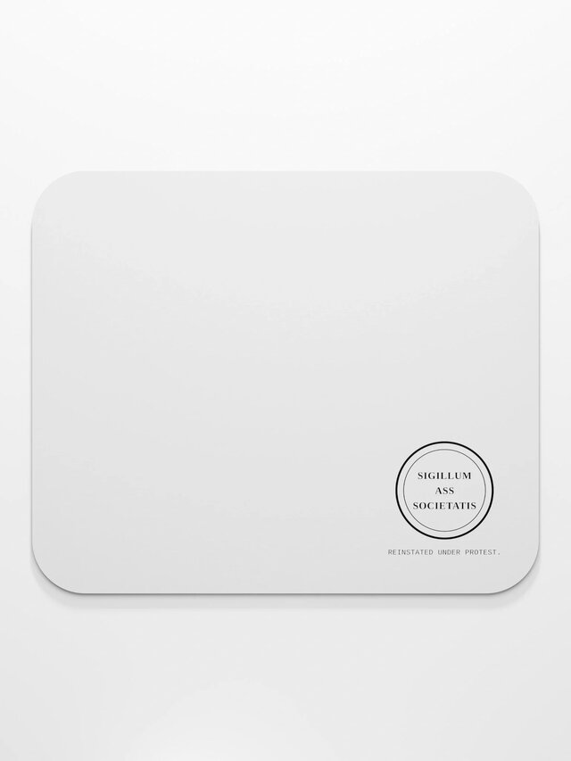 Photograph of the white mousepad, seal in one corner.
